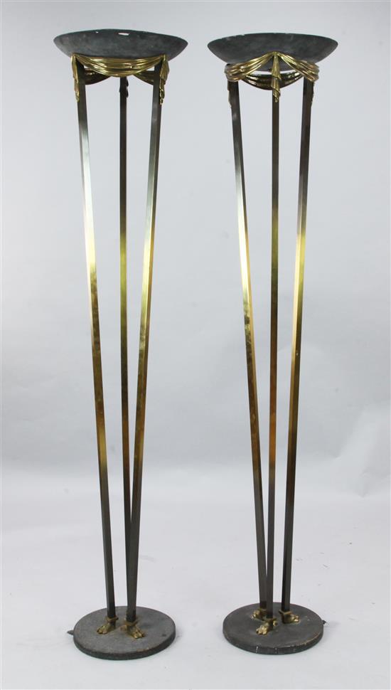 A pair of parcel ebonised brass uplighters, H.5ft 11in.